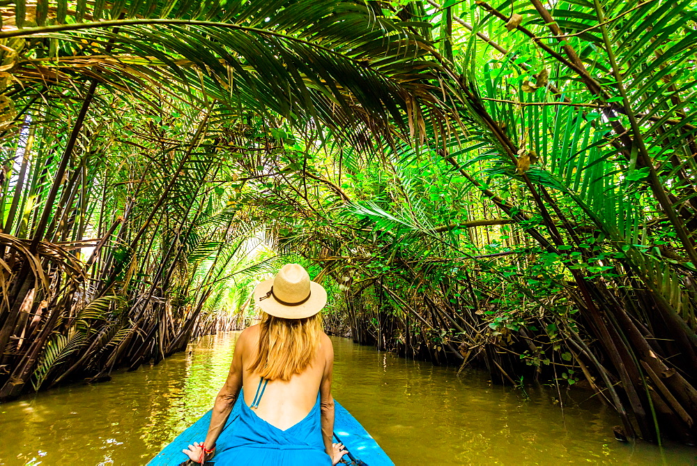 Sailing the tributaries of the Mekong River to reach a village to see how they make coconut candy, Vietnam, Indochina, Southeast Asia, Asia