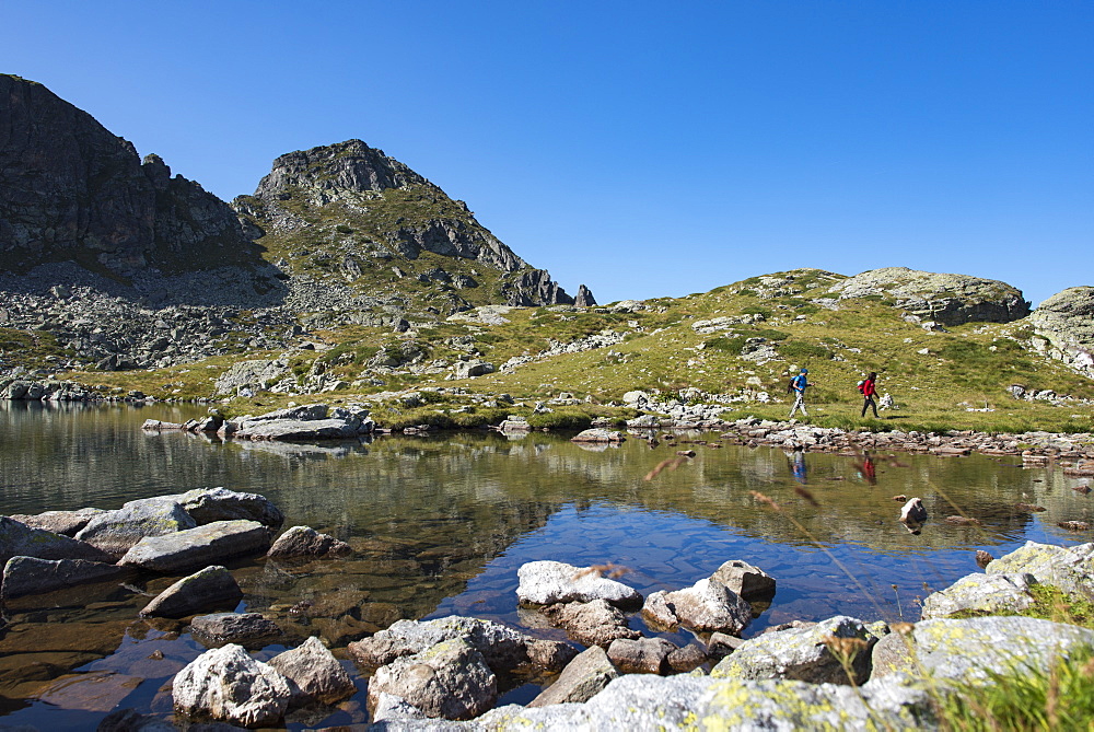 Hiking next to the clear water of Elenino Lake near Maliovitsa in the Rila Mountains, Bulgaria, Europe