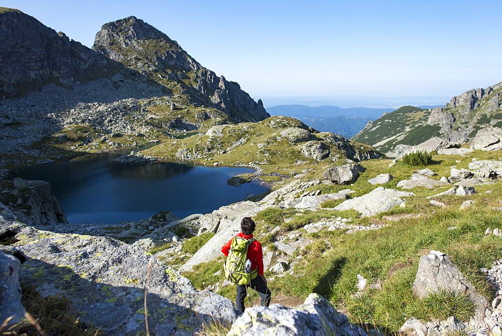 Hiking next to the clear water of Elenino Lake near Maliovitsa in the Rila Mountains, Bulgaria, Europe