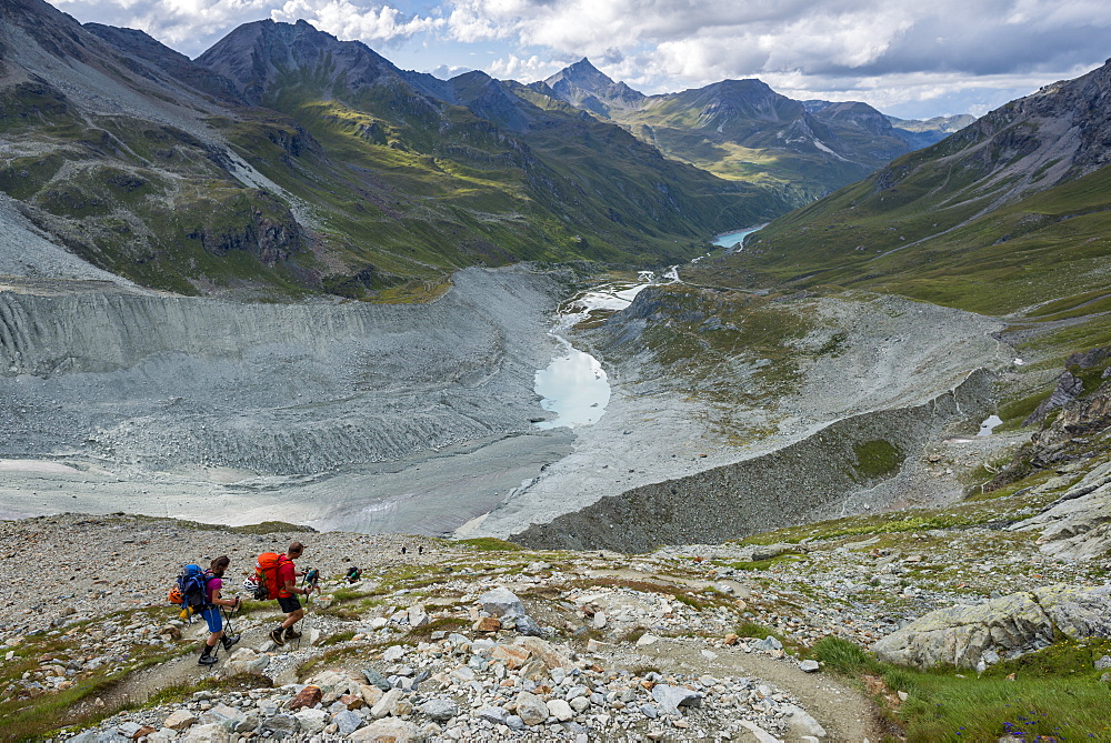 Hikers beside the Moiry Glacier on the Walkers Haute Route from Chamonix to Zermatt, Swiss Alps, Valais, Switzerland, Europe