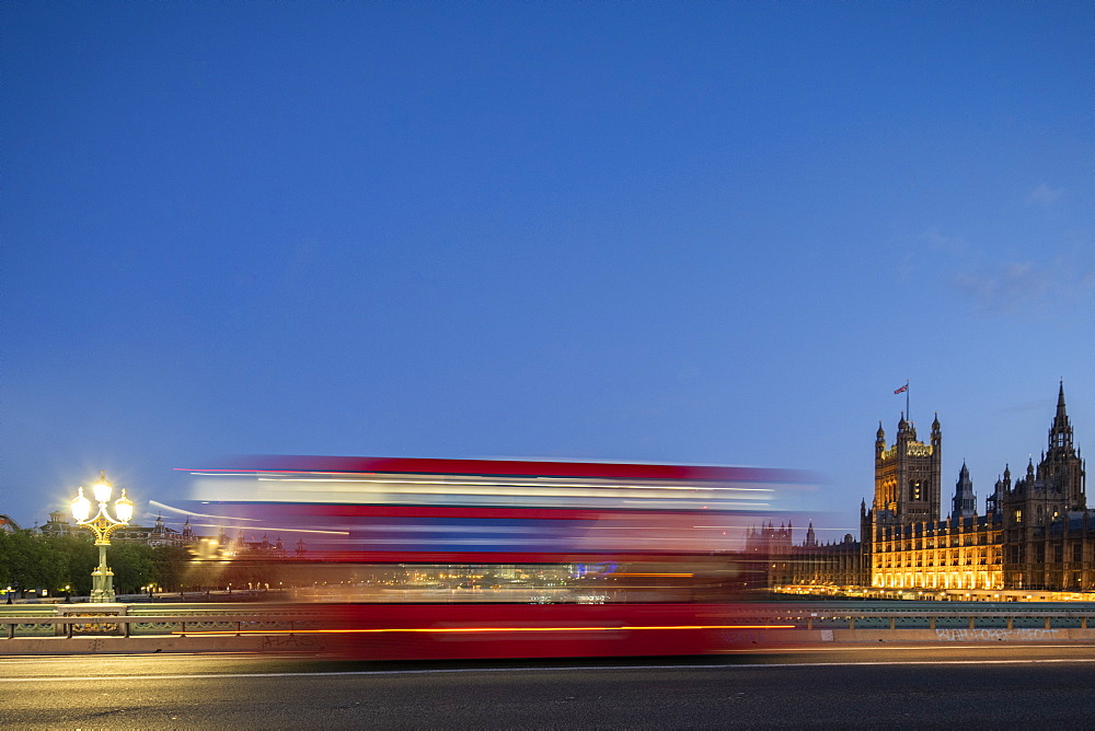 A red London bus goes past in a blur across Westminster Bridge, London, England, United Kingdom, Europe