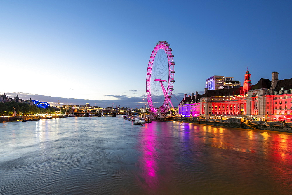 The London Eye lit up pink during blue hour, and River Thames, London, England, United Kingdom, Europe