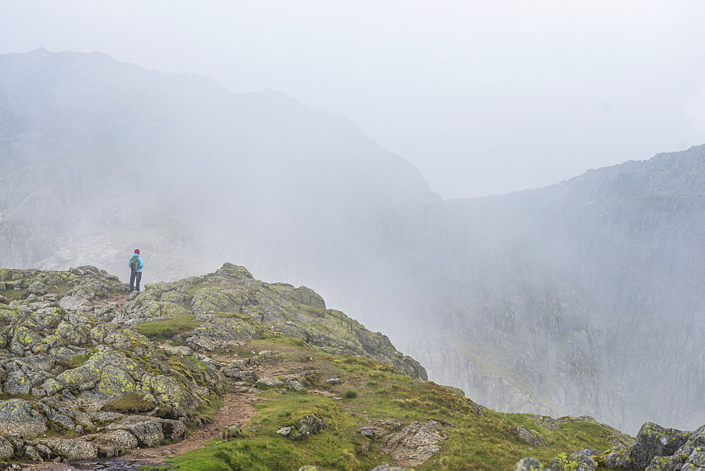 Walking across Crinkle Crags near Great Langdale in The Lake District National Park, Cumbria, England, United Kingdom, Europe