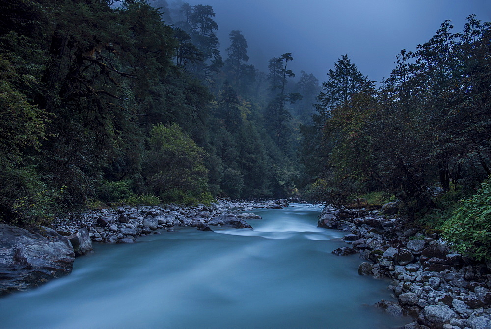 Langtang Khola near the little village of Riverside on a misty evening in the Langtang region of Nepal, Himalayas, Asia