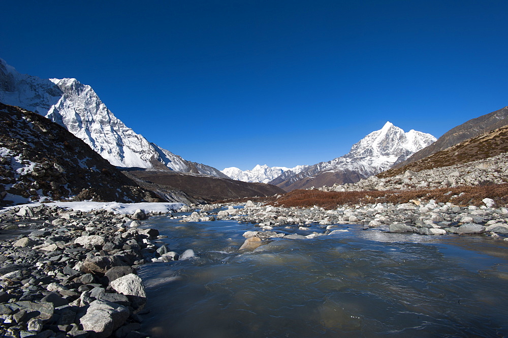 Icy meltwater flows down the Chekhung valley with views of Ama Dablam to the left and Taboche to the right, Khumbu Region, Nepal, Himalayas, Asia