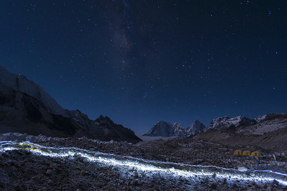 Departure of the Sherpas, their head-torches leaving trails of light across the glacier on their way to Everest, Nepal, Himalayas, Asia