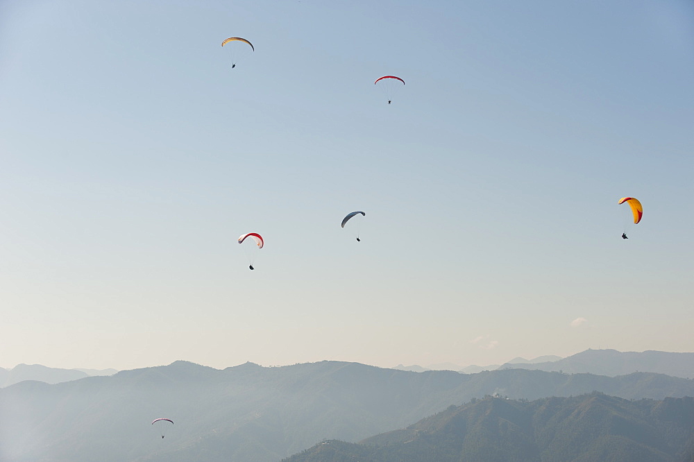 Paragliders flying above Pokhara, Nepal, Himalayas, Asia