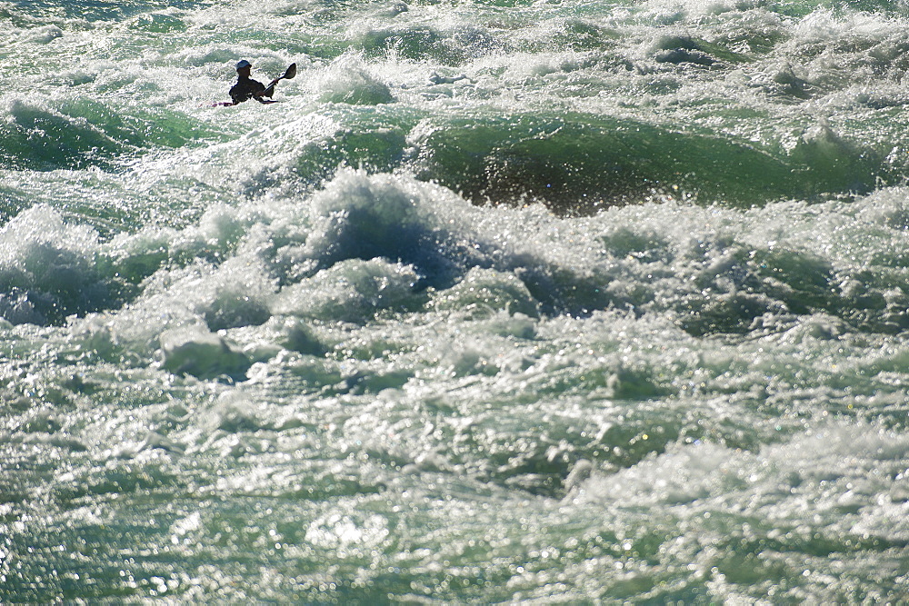 A kayaker negotiates his way through the rapids on the Karnali River in west Nepal, Asia