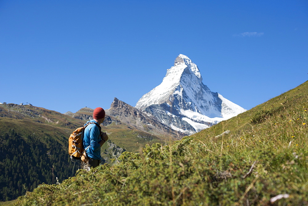 Trekking in the Swiss Alps near Zermatt with a view of the Matterhorn in the distance, Zermatt, Valais, Switzerland, Europe