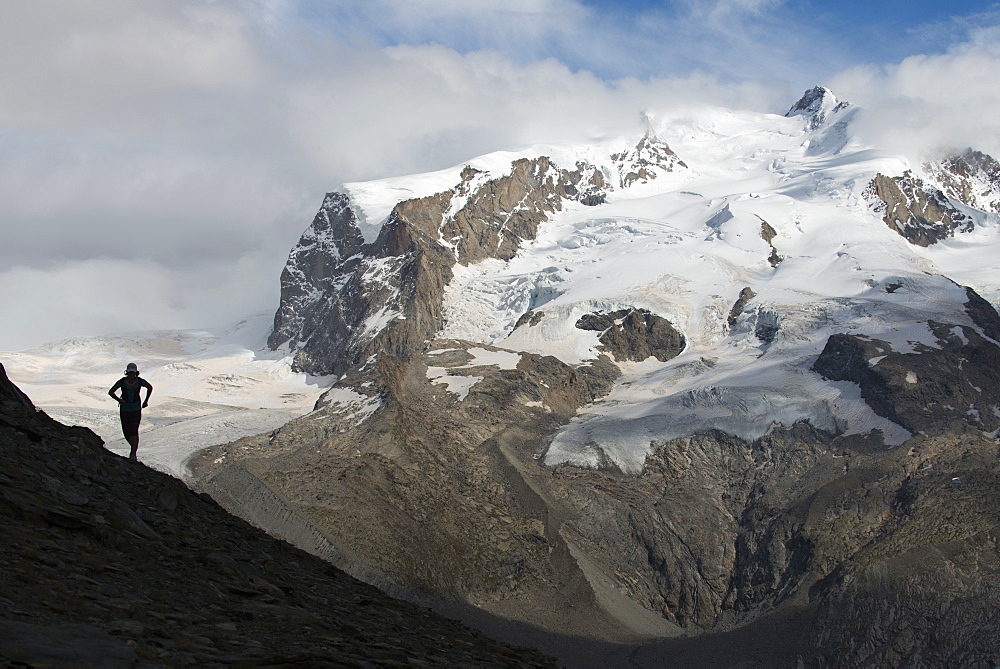 Running in the Swiss Alps near Zermatt with a view of Monte Rosa, Zermatt, Valais, Switzerland, Europe