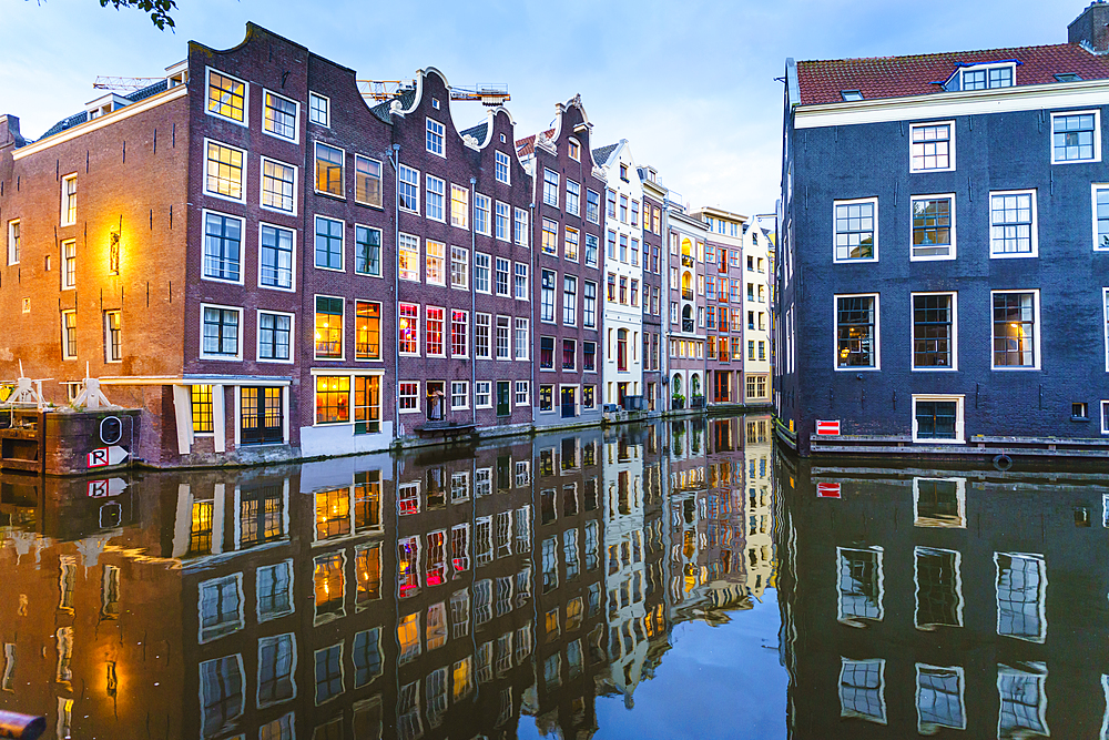 Old gabled buildings by a canal at dusk, Oudezijds Kolk, Amsterdam, North Holland, The Netherlands, Europe