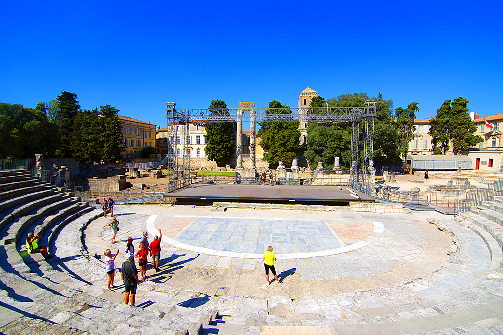 A group of tourists visit the Roman ruins in Arles, a city on the Rhone River, Arles, Bouches-du-Rhone, Provence, France, Europe