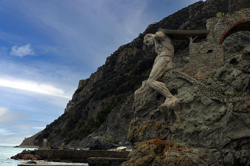 Il Gigante, a stone sculpture representing Neptune, Roman god of the sea, at the end of Fegina Beach, Monterosso al Mare, Cinque Terre, UNESCO World Heritage Site, Liguria, Italy, Europe.