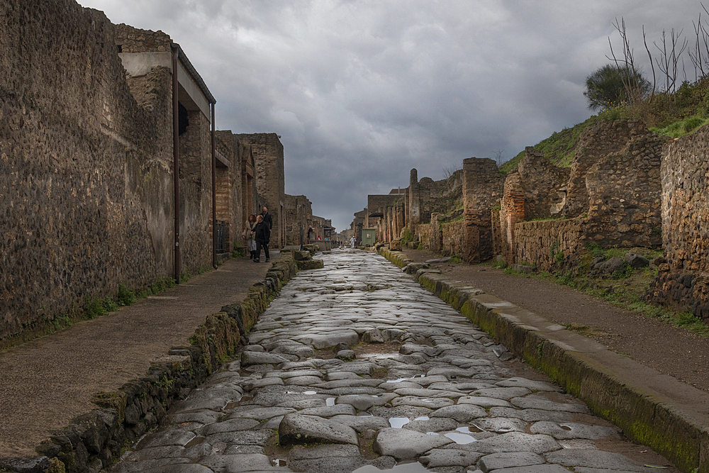 A cobblestone street running through the centre of the Roman ruins of Pompeii. Italy.