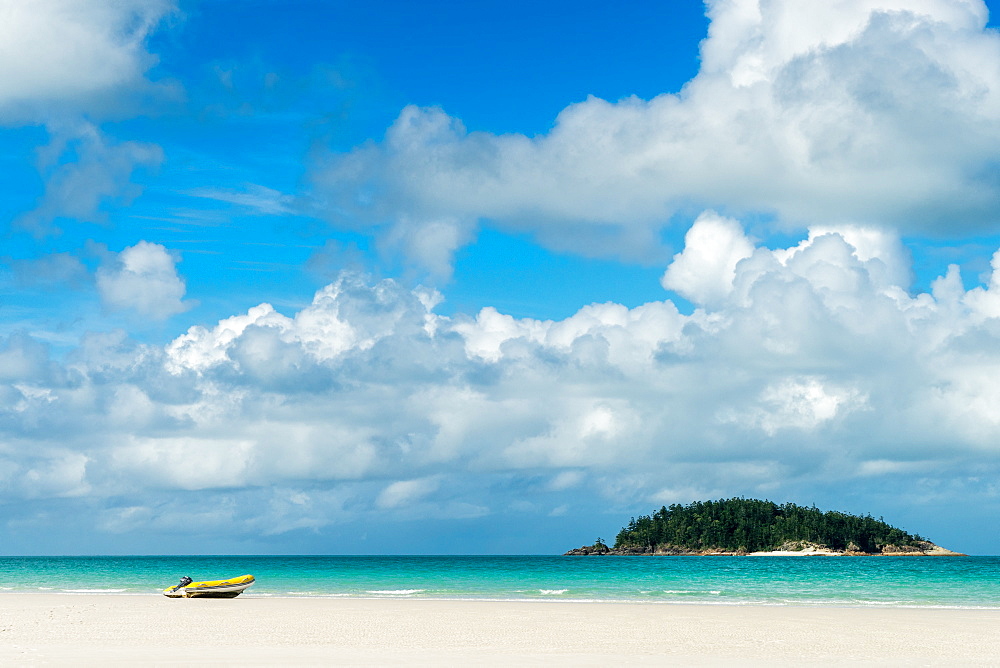 A small dinghy sits on the white sand of Whitehaven Beach, Whitsunday Island, Australia, Pacific