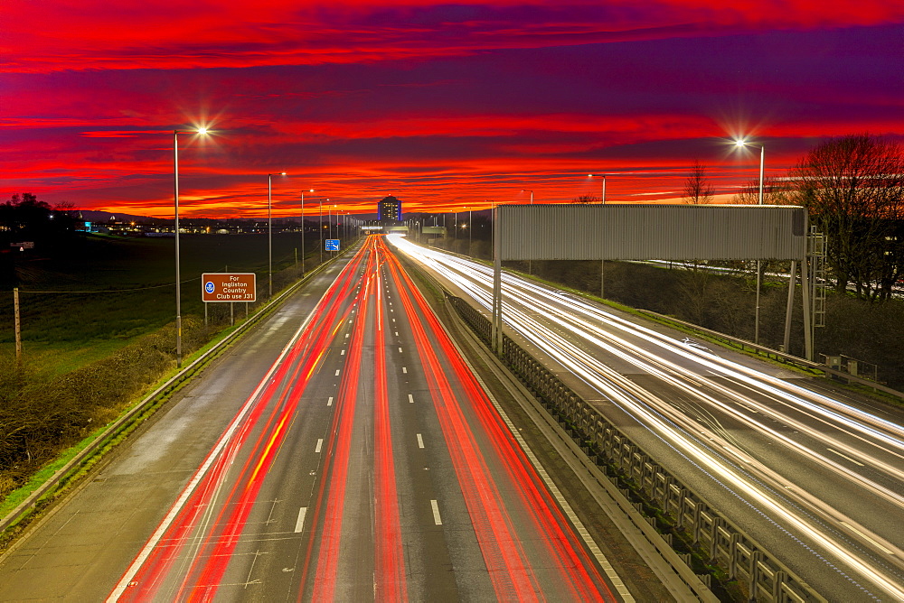 Red sky sunset, traffic light trails, M8 Motorway, Scotland, United Kingdom, Europe