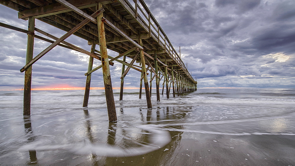 Beach, ocean, waves and pier at sunrise, Sunset Beach, North Carolina, United States of America, North America