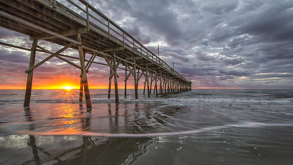 Beach, ocean, waves and pier at sunrise, Sunset Beach, North Carolina, United States of America, North America