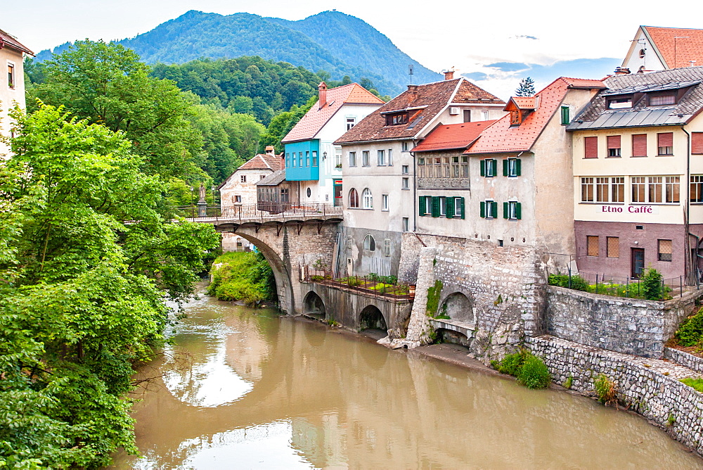 Houses lining a river, Skofja Loka village, near Ljubljana, Slovenia, Europe