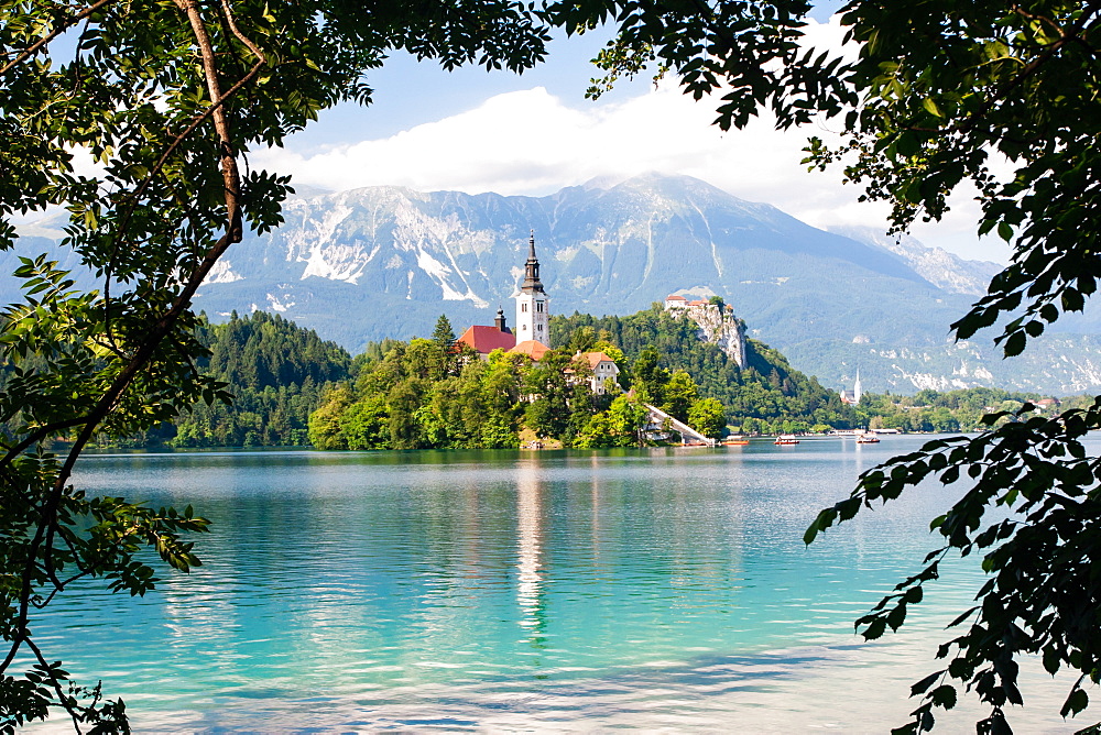 Tiny island with a church, a castle on a crag, and mountain views, Lake Bled, Slovenia, Europe