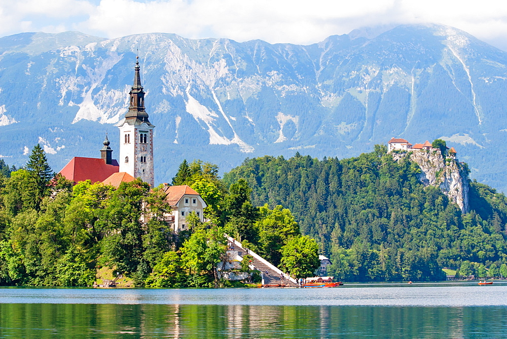 Tiny island with a church, a castle on a crag, and mountain views, Lake Bled, Slovenia, Europe