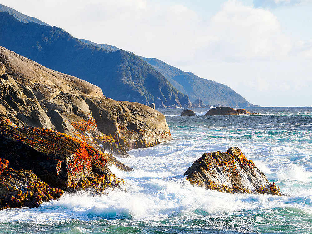 Crashing waves on rocks at the entrance to Doubtful Sound, Fiordland National Park, Te Wahipounamu, UNESCO World Heritage Site, South Island, New Zealand, Pacific