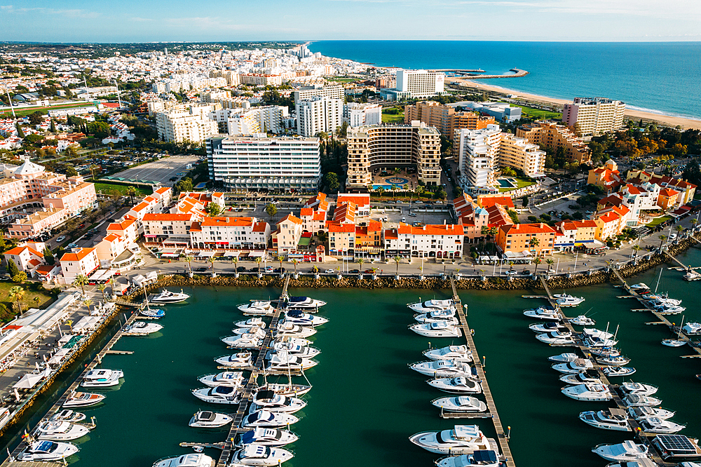 Aerial view of the tourist Portuguese town of Vilamoura, with yachts and sailboats moored in the port on the marina, Vilamoura, The Algarve, Portugal, Europe