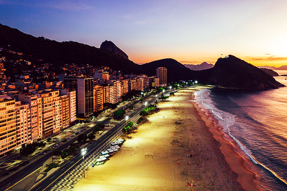 Aerial drone view of Leme Beach in the Copacabana district at sunrise with the iconic Sugarloaf Mountain in the background, UNESCO World Heritage Site, Rio de Janeiro, Brazil, South America