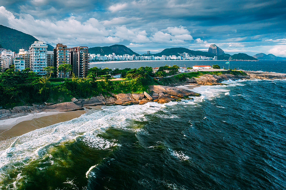 Aerial drone view of Arpoador section of Ipanema Beach with Copacabana and Sugarloaf Mountain visible in the background, Rio de Janeiro, Brazil, South America