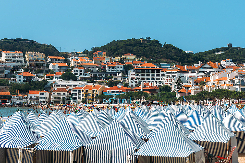 View of green huts at Sao Martinho do Porto beach, a wide white-sand beach, backed by dunes in a secluded bay popular with families, Oeste, Portugal, Europe