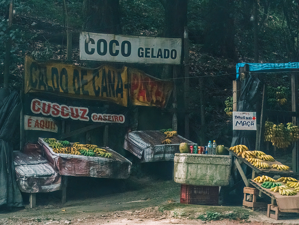 A weathered stand next to a highway selling different types of tropical fruits and local products outside Rio de Janeiro, Brazil, South America