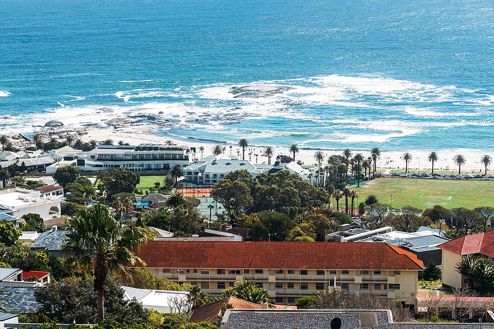 Upmarket Camps Bay  draws crowds to its namesake beach, known for fine white sand, natural rock swimming pool and views of the Twelve Apostles mountains, Cape Town, Western Cape, South Africa, Africa