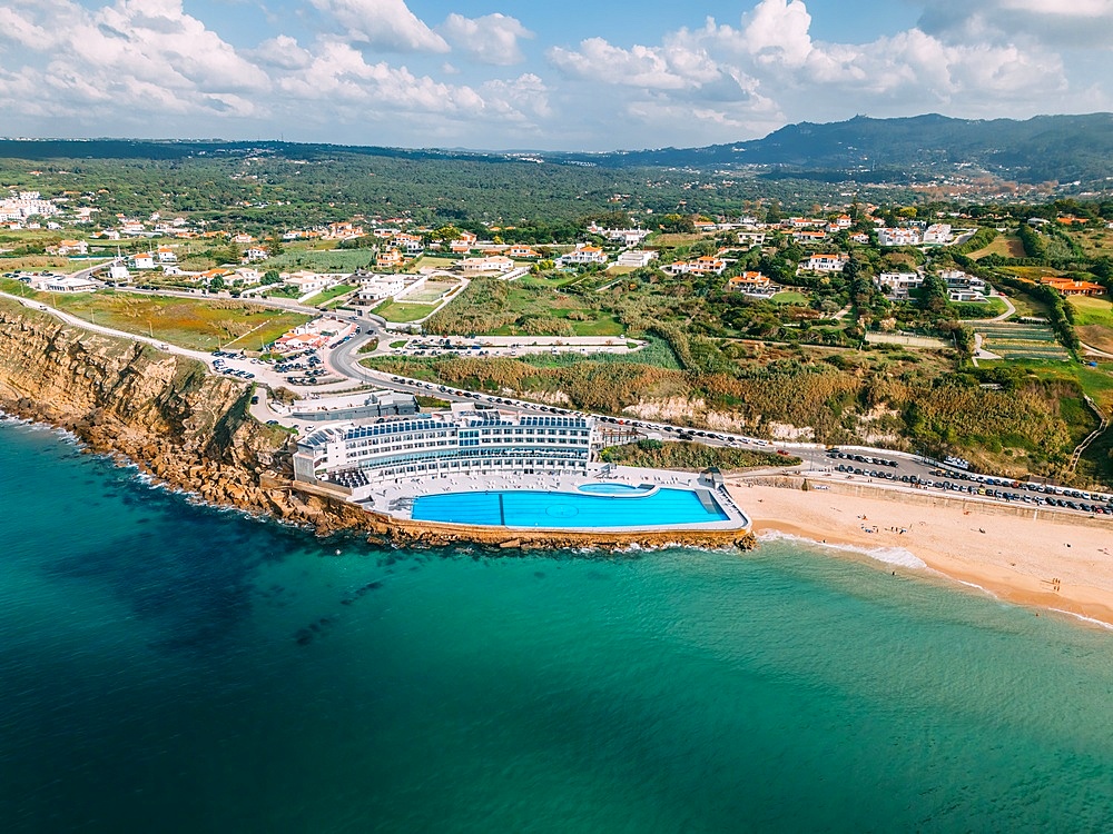 Praia Grande is the largest beach on the Sintra coast, Portugal on an expanse of white sand that delights holidaymakers and also a popular place for surfers. The 100m swimming pool belonging to Arribas Hotel is the largest seawater pool in Europe