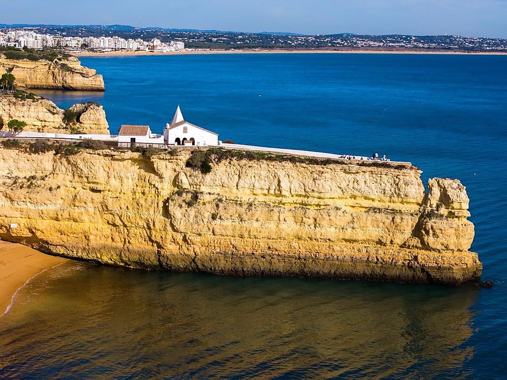 Aerial drone view of the Fort of Nossa Senhora da Rocha (also known as the Fort of Our Lady of the Rock or Castle of Porches), a medieval castle situated in the civil parish of Porches, in the municipality of Lagoa in Portuguese Algarve