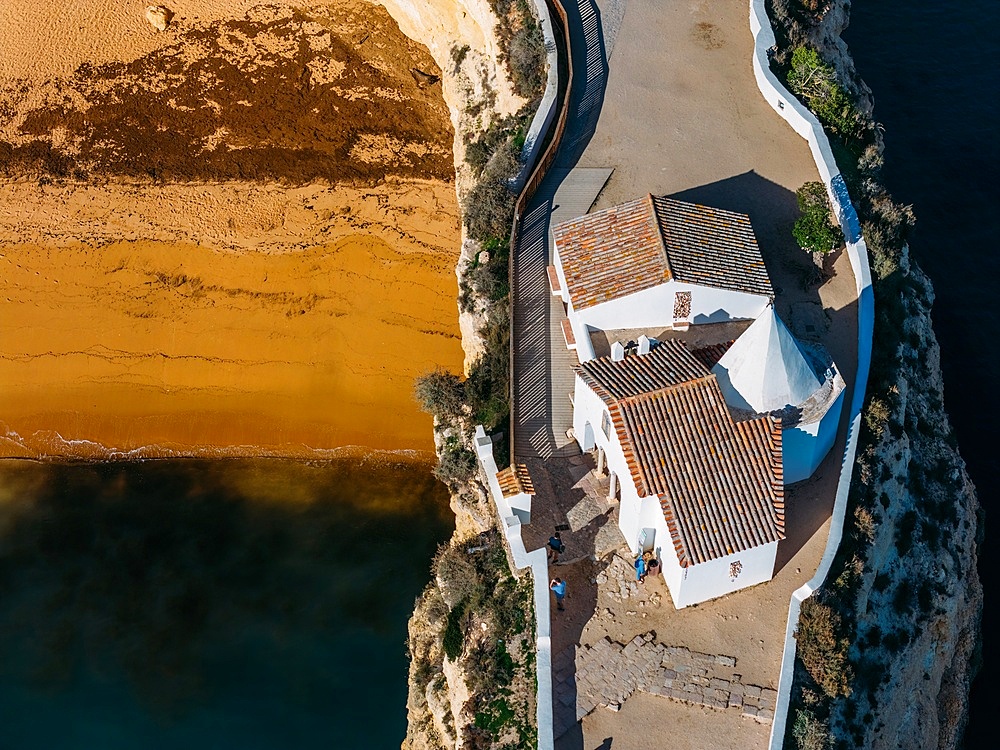 Aerial drone view of the Fort of Nossa Senhora da Rocha (also known as the Fort of Our Lady of the Rock or Castle of Porches), a medieval castle situated in the civil parish of Porches, in the municipality of Lagoa in Portuguese Algarve