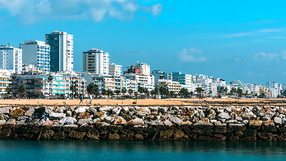 View of beach and promenade at Quarteira, Algarve, Portugal