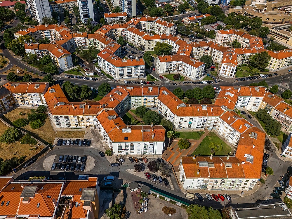 Aerial drone view of geometric Soviet-era apartment blocks in Carnaxide district in Lisbon, Portugal
