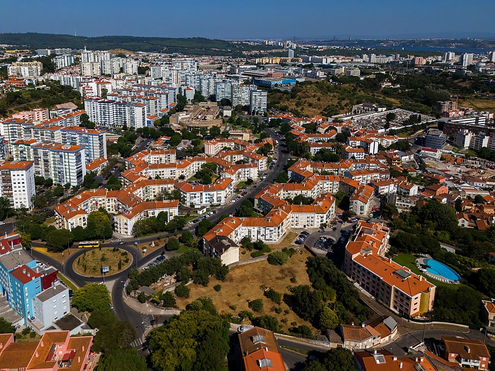 Aerial drone view of geometric Soviet-era apartment blocks in Carnaxide district in Lisbon, Portugal
