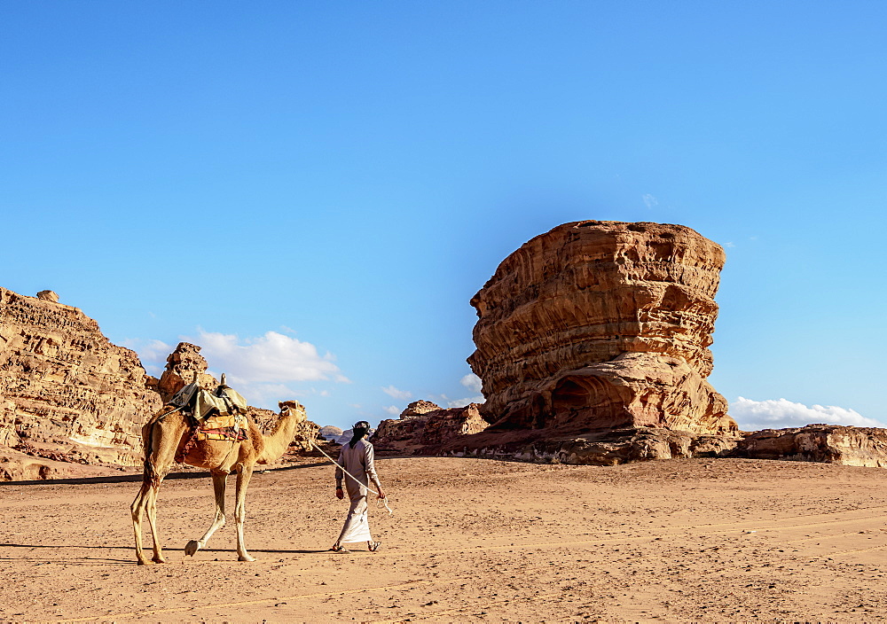 Bedouin walking with his camel, Wadi Rum, Aqaba Governorate, Jordan, Middle East