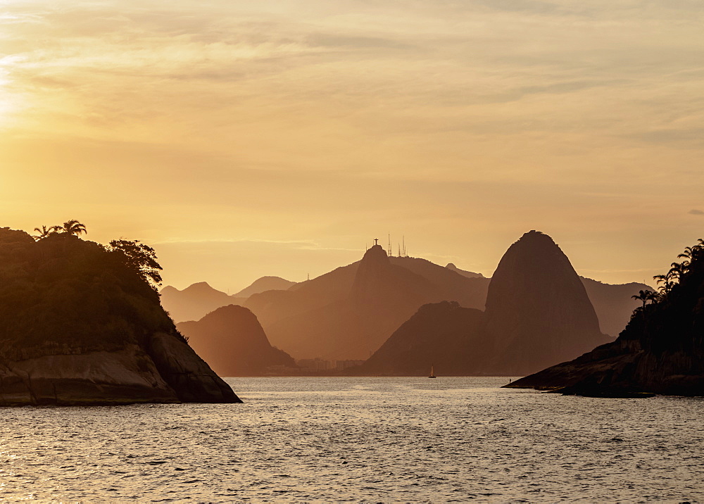 View over rocks of Piratininga towards Rio de Janeiro, sunset, Niteroi, State of Rio de Janeiro, Brazil, South America