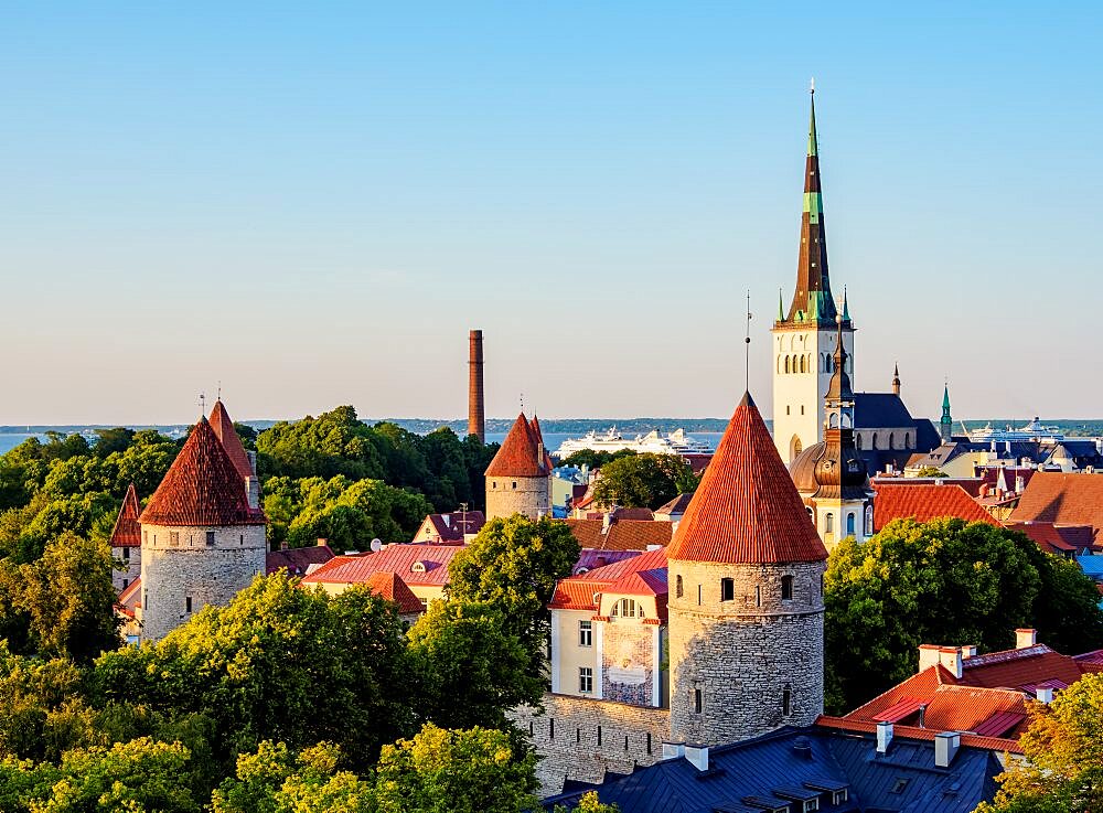 View over the Old Town towards St Olaf's Church at sunset, Tallinn, Estonia