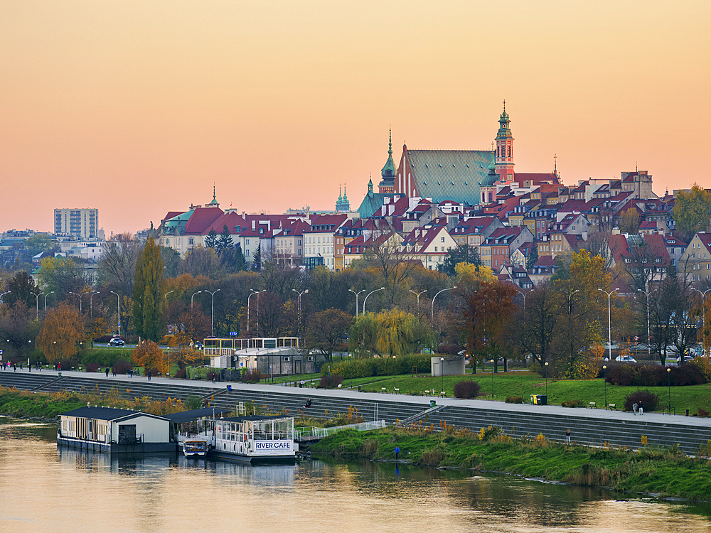 View over River Vistula towards The Old Town at sunset, Warsaw, Masovian Voivodeship, Poland, Europe