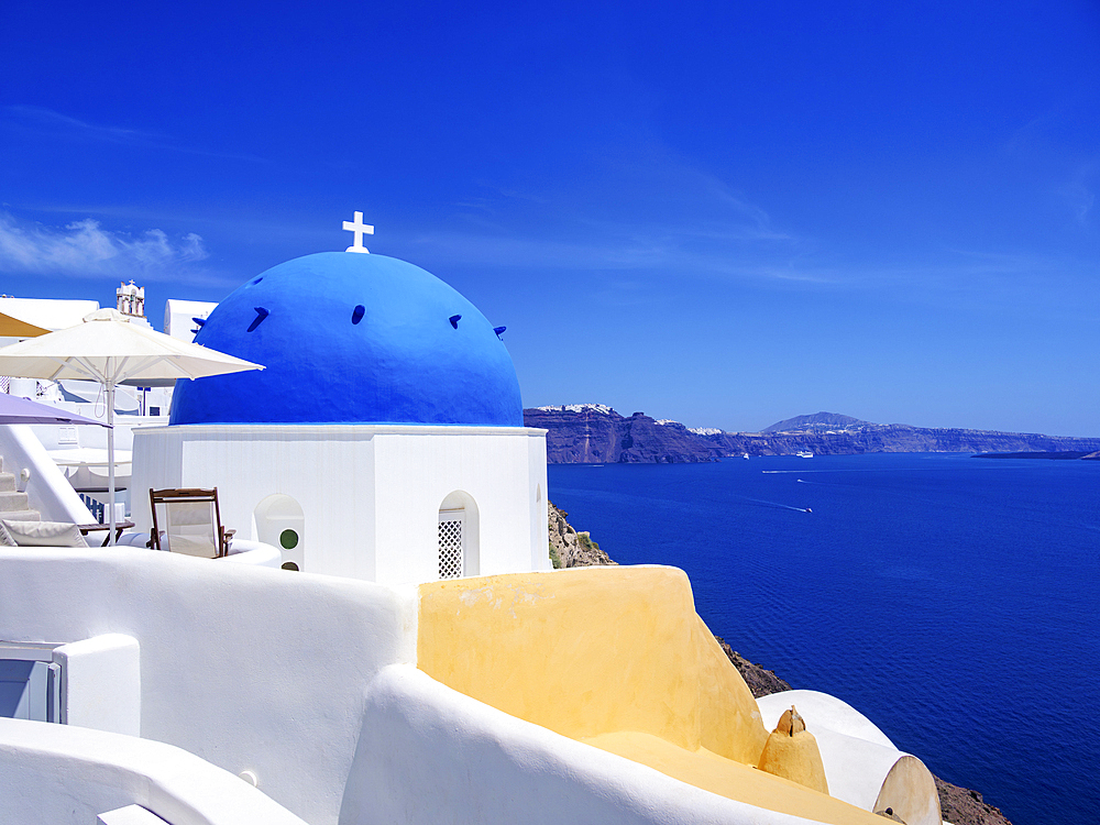 Iconic blue domed church of Saint Spyridon, Oia Village, Santorini (Thira) Island, Cyclades, Greek Islands, Greece, Europe