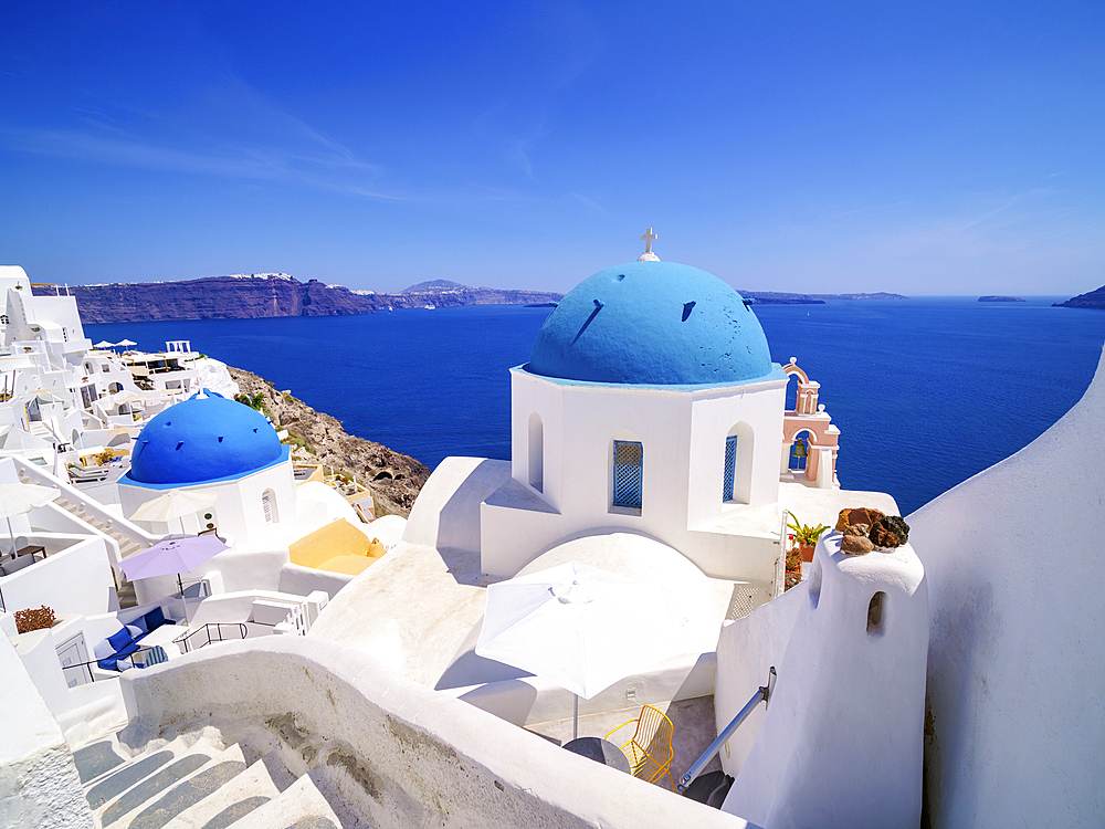 Iconic blue domed churches of Resurrection of the Lord and Saint Spyridon, Oia Village, Santorini (Thira) Island, Cyclades, Greek Islands, Greece, Europe