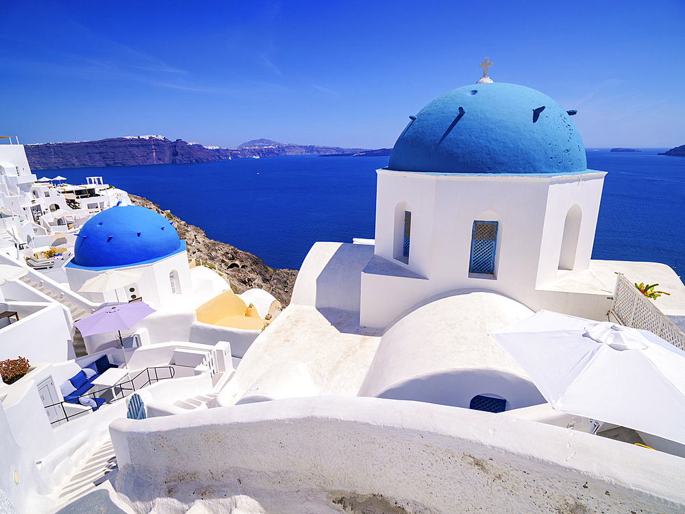 Iconic blue domed churches of Resurrection of the Lord and Saint Spyridon, Oia Village, Santorini (Thira) Island, Cyclades, Greek Islands, Greece, Europe