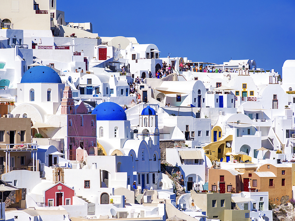 View towards the blue domed churches of Resurrection of the Lord and Saint Spyridon, Oia Village, Santorini (Thira) Island, Cyclades, Greek Islands, Greece, Europe