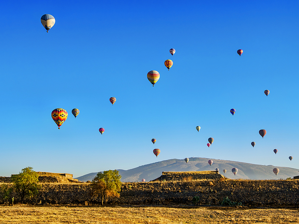 Hot air balloons flying over the Teotihuacan Archaeological Site at sunrise, Mexico State, Mexico