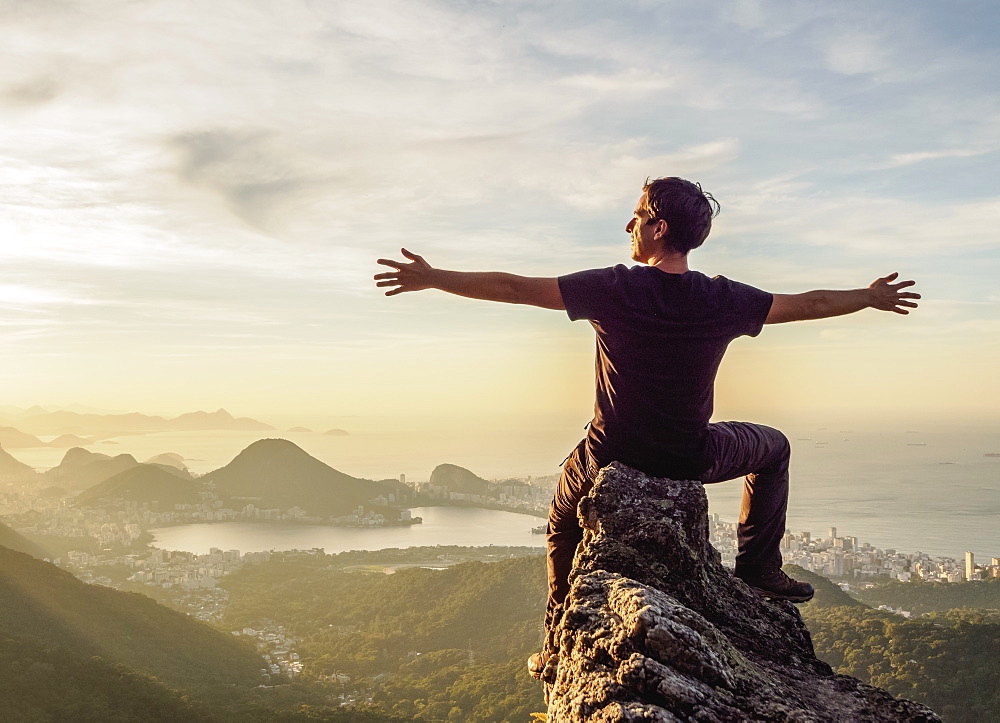 Hiker enjoying the view of Rio de Janeiro from Pedra da Proa, Tijuca Forest National Park, State of Rio de Janeiro, Brazil, South America