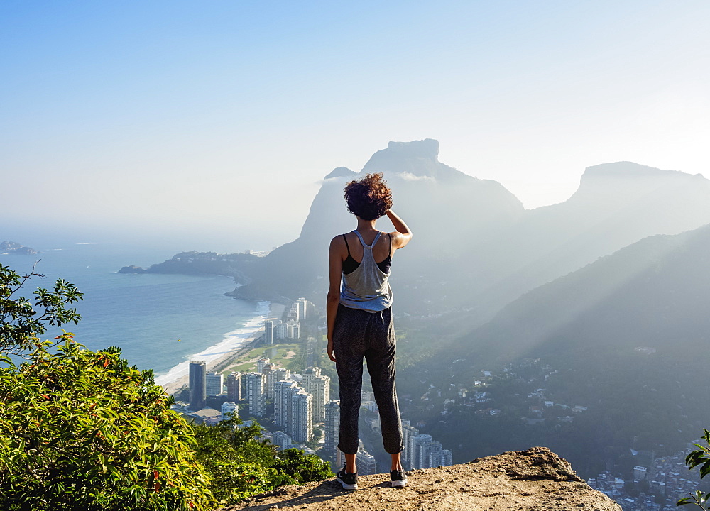 Brazilian girl looking towards the Pedra da Gavea and Sao Conrado from Dois Irmaos Mountain, Rio de Janeiro, Brazil, South America