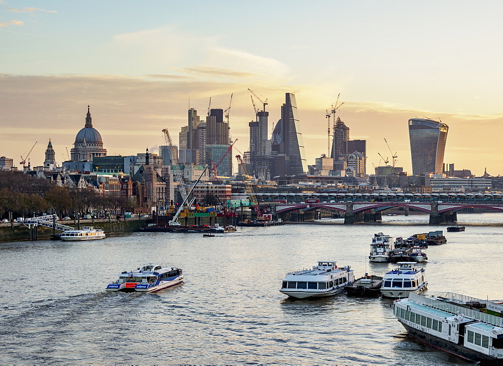 View over River Thames towards City of London at sunrise, London, England, United Kingdom, Europe